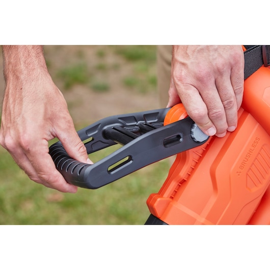 BLACKDECKER BCBLV36B orange leaf blower handle adjustment detail outdoor photography.