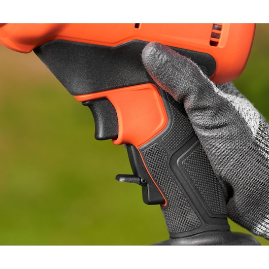BLACKDECKER BCPP18D1 drill handle close-up with textured grip and trigger, held by gloved hand.