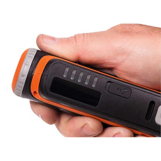 Close-up of BLACK+DECKER BCRT8I handheld tool with USB port and LED indicators, held in hand.