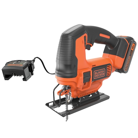 A BLACK+DECKER cordless jigsaw with an orange and black design, featuring an 18V lithium battery and a separate battery charger connected by a cable.