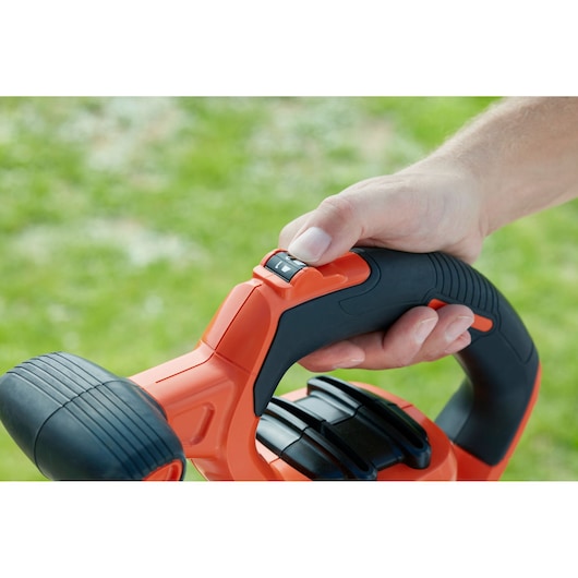 BLACKDECKER BEBLV301 leaf blower handle close-up with control switch, outdoor photography.