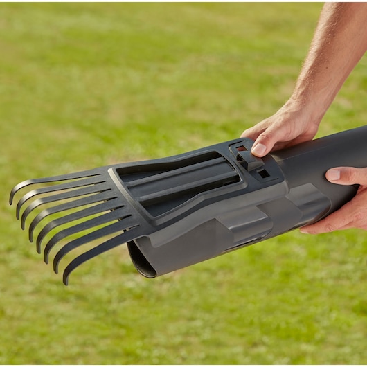 BLACKDECKER BEBLV301 leaf blower tube with rake attachment held outdoors.
