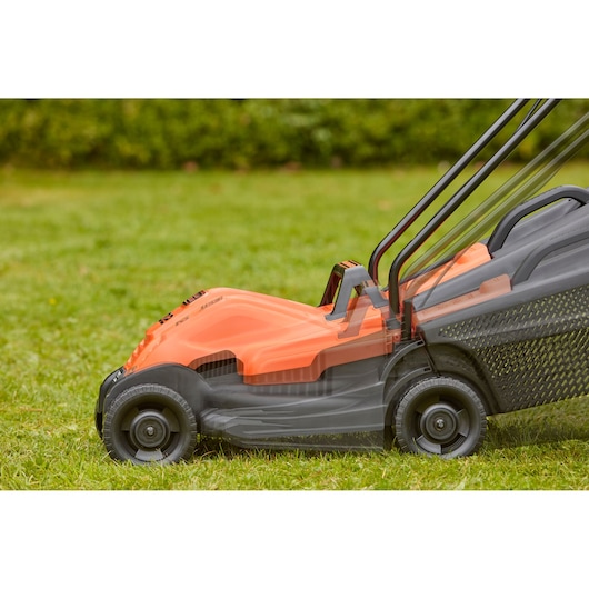 BLACKDECKER BEMW451BH lawn mower side view on grass, showing adjustable handle and orange body.