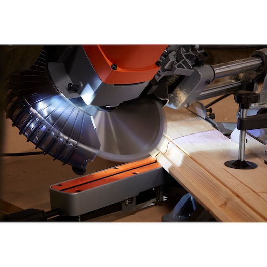 BLACKDECKER BES700 miter saw cutting wood with LED light in workshop, close-up angle