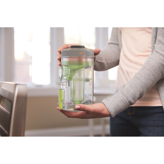 BLACKDECKER BHFEV362DA vacuum dust container held by person indoors.