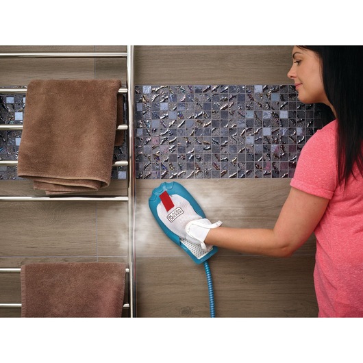 BLACKDECKER BHSM1610DSM steam cleaning glove cleaning bathroom wall tiles next to towel rack.