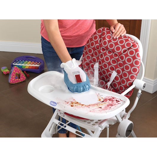BLACKDECKER BHSM1615DSM steam cleaning glove cleaning food stains from a highchair tray, red patterned seat visible.