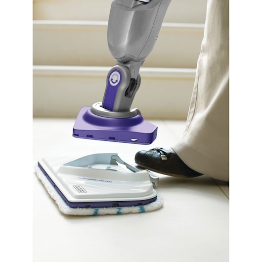BLACK+DECKER BHSM1615DSM steam mop head close-up with foot pedal on white tile floor.