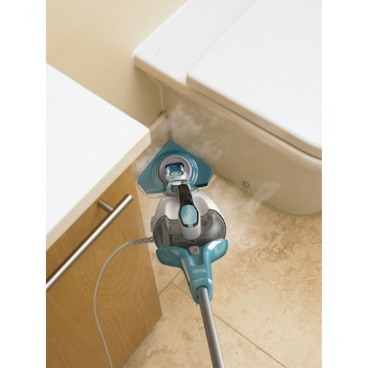 BLACKDECKER BHSM168DSM steam mop cleaning bathroom floor near toilet and cabinet, angled for corner reach.