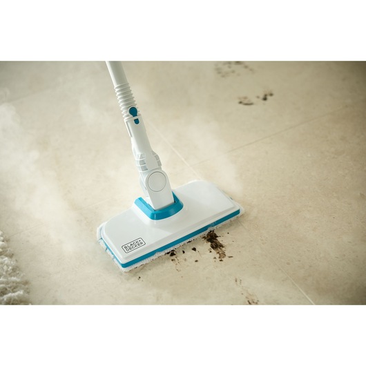 BLACKDECKER BHSMP2008 steam mop cleaning dirty tile floor, close-up photo.