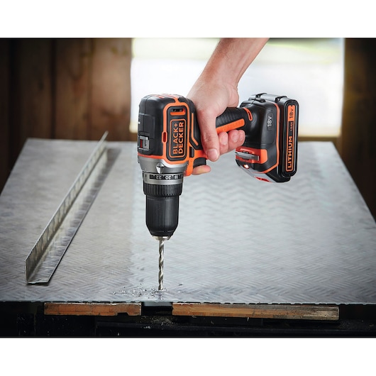 Photo of BLACKDECKER BL186K1B2 cordless drill in use on metal surface, 18V, with Lithium battery.
