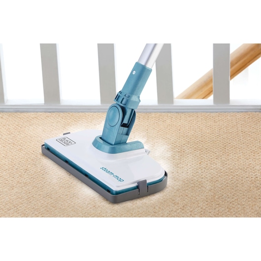 BLACKDECKER FSMCG steam mop cleaning beige carpet, side angle indoor photo.