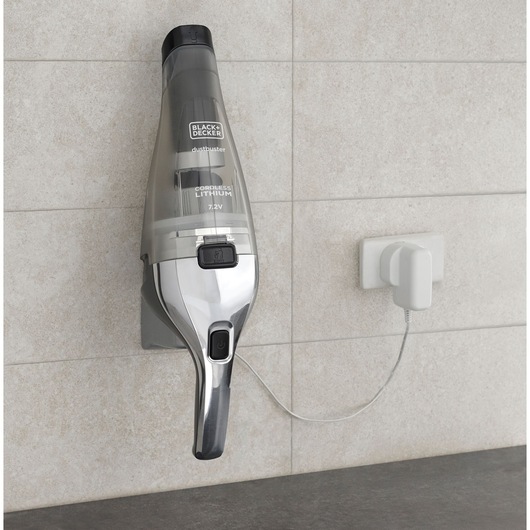Photo of BLACK+DECKER NVC220WC cordless handheld vacuum on wall charger, side view.