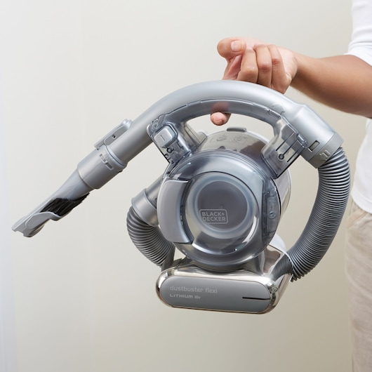 BLACKDECKER PD1820L handheld vacuum cleaner with flexible hose, shown in a person’s hand.