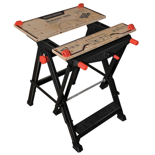 A BLACK+DECKER Workmate 1000 portable workbench with a wooden top, black metal frame, and red adjustment knobs. The workbench features measurement guides and clamping holes on the surface.